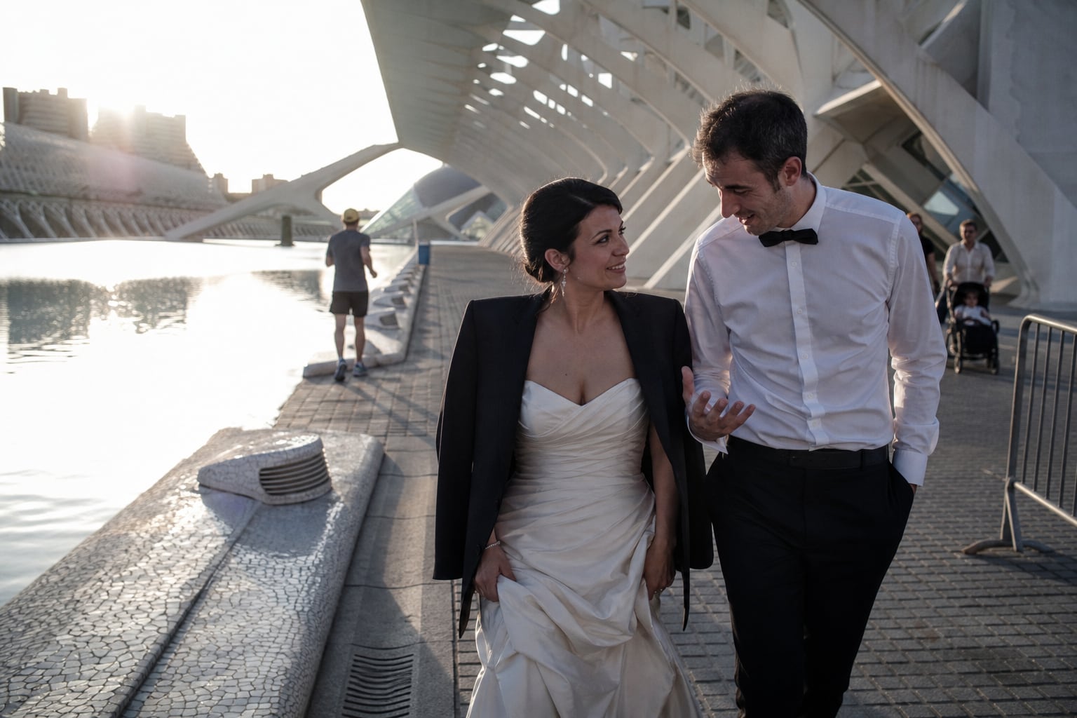 Newlyweds by the white arches of the City of Arts and Sciences in Valencia